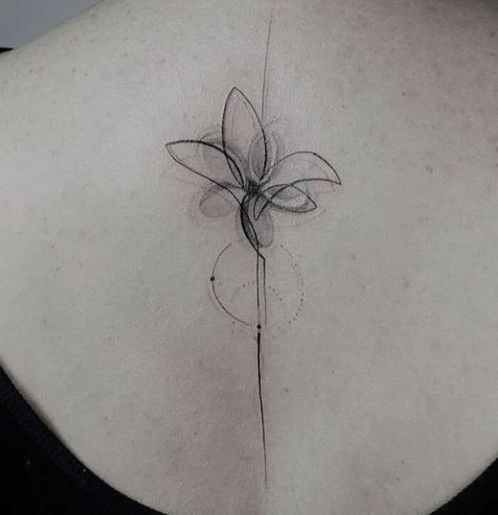 Geometric tattoo on back, featuring abstract flower design with fine lines and shapes.