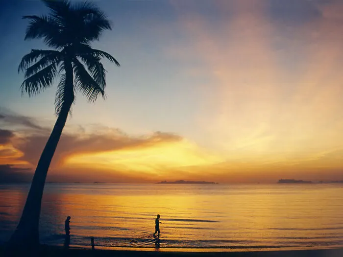 People walking at sunset in Koh Samui