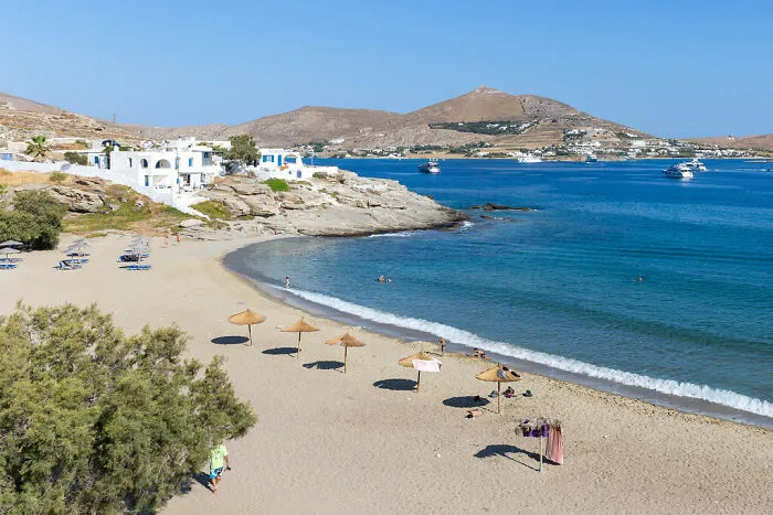Beach with houses near in Paros