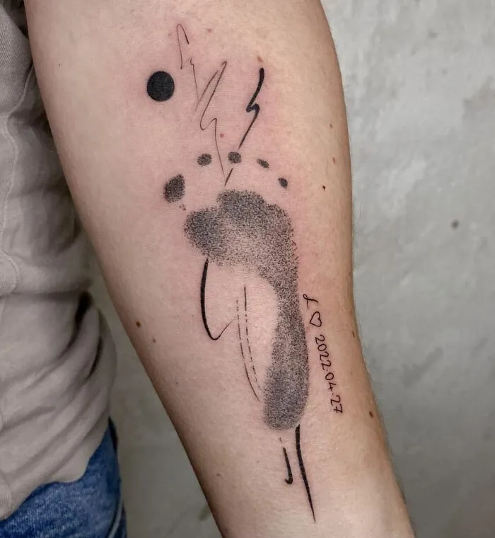 Abstract geometric tattoo with shapes and lines on an arm, showcasing creativity and modern design.