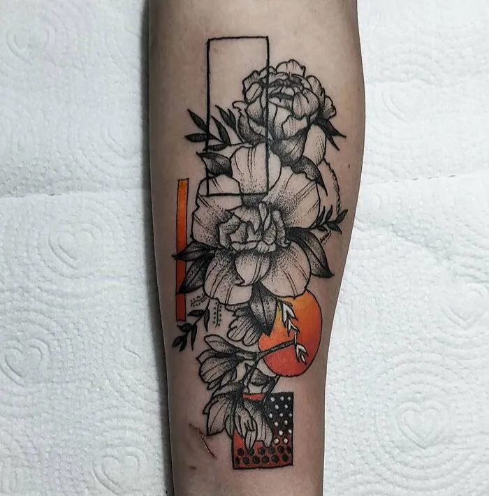 Geometric tattoo with floral designs, featuring shapes and forms on an arm.