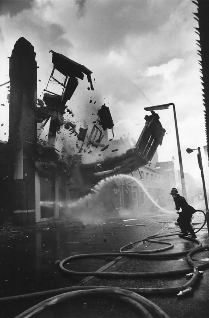 1972. A Burning Wall Crumbles Down, Belfast, Northern Ireland. Photo By A. Abbas