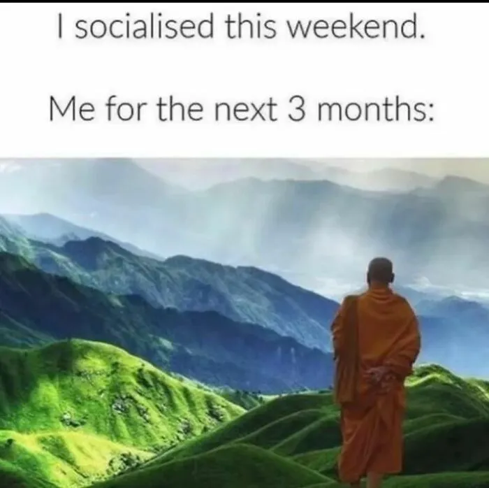 Monk overlooking green mountains with text about socializing and solitude, related to memes and therapy discussion.