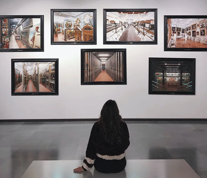 Woman looking at paintings