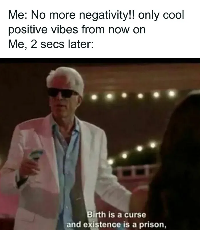 Person in sunglasses with a skeptical expression, contrasting positive vibes. Text: "Birth is a curse, existence is a prison."