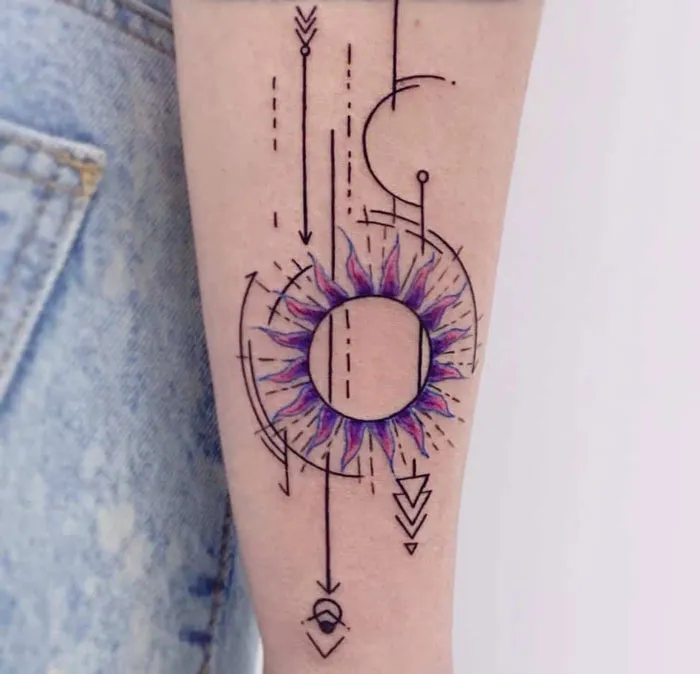 Geometric tattoo design featuring circles, arrows, and abstract forms on forearm, showcasing creative shapes and artistry.