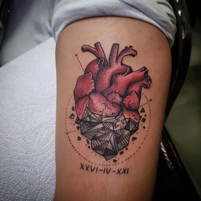 Geometric tattoo of a heart with shapes and forms on an arm, featuring intricate details and creativity.