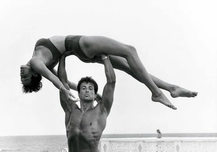 Behind Every Successful Woman Stands A Man Who... Well.. In Most Cases He Just Stands There For, You Know, Safety Reasons. Anyway, Here’s Brigitte Nielsen With Some Dude In 1986