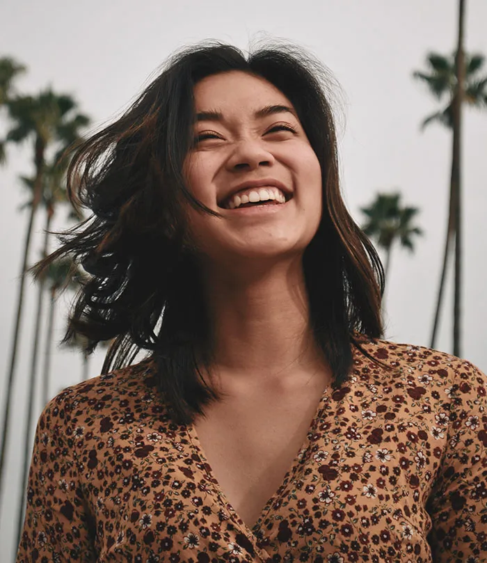 Woman standing and laughing
