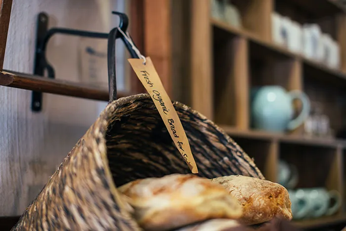 Fresh baked baguettes in wicker bucket in market
