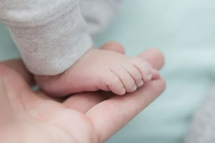 a little foot of a newborn