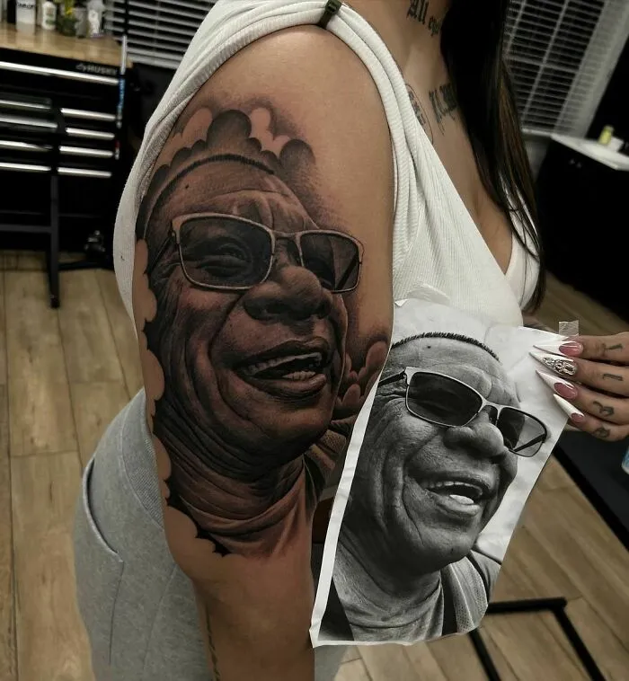 Realistic family portrait tattoo on arm, showcasing intricate detailing and artistry.