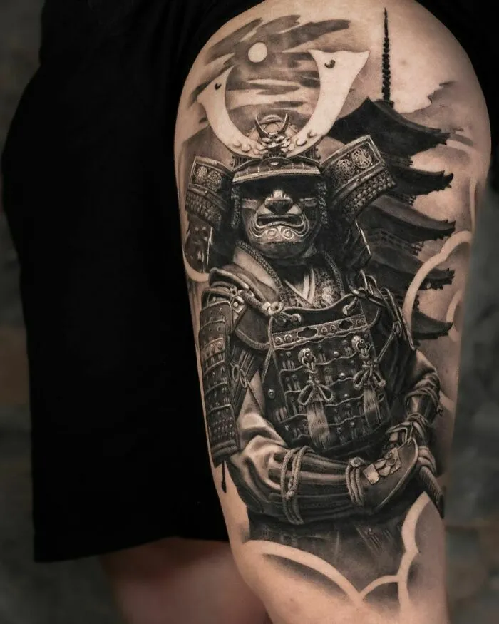 Super realistic tattoo of a Japanese samurai with a pagoda in the background, showcasing intricate detailing.