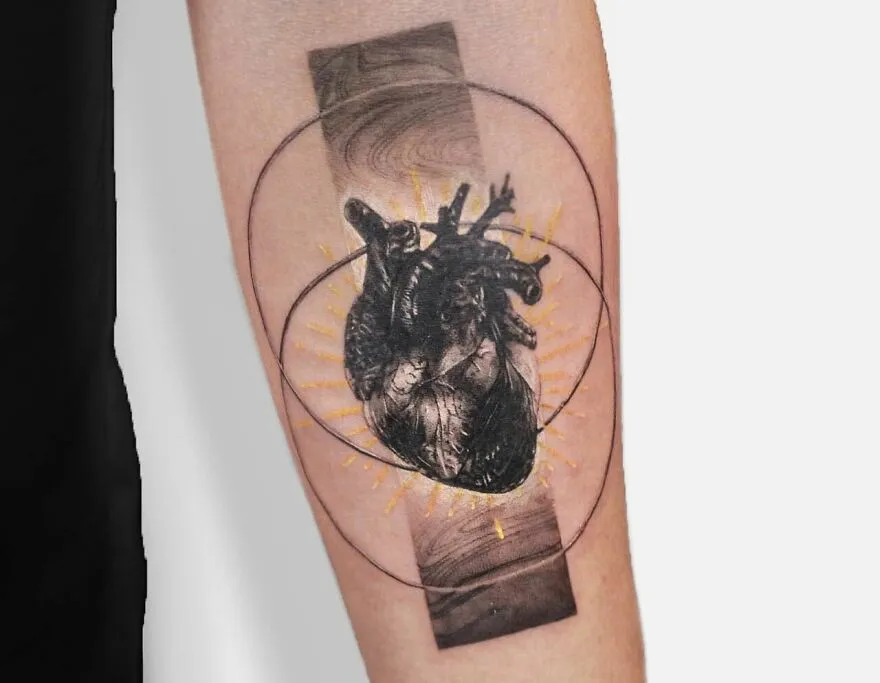 Realistic heart and geometric patterns tattoo on forearm, highlighting intricate detailing.