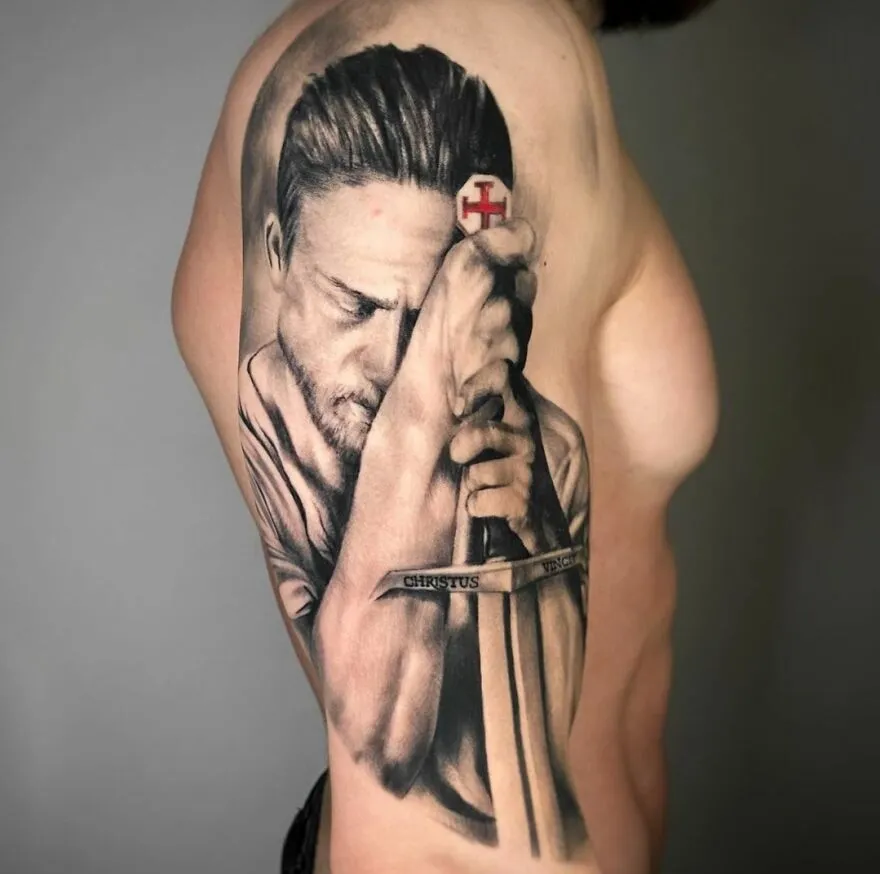 Realistic tattoo of a Last Templar theme with a man holding a sword, showcasing intricate detailing.