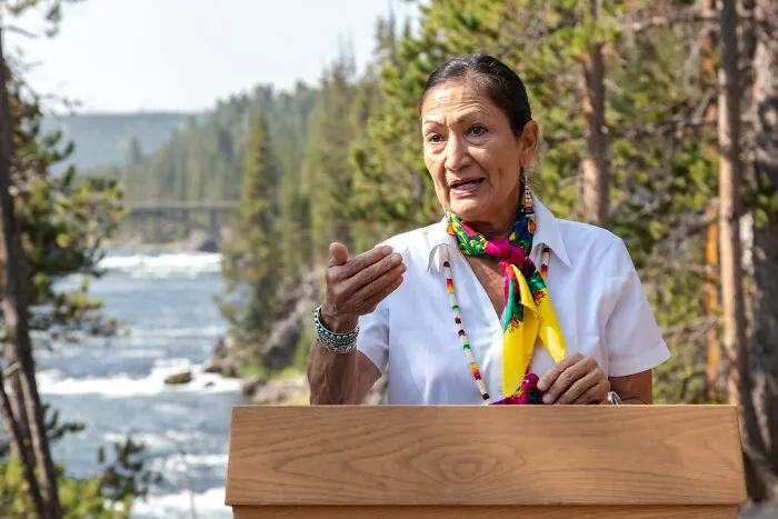 woman telling something on the background of the river