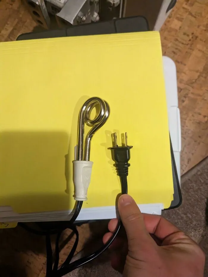 A Short Thick Metal Coil That Can Be Plugged Into An Outlet. Doesn't Seem Very Safe At All. I'm Thinking It's Missing A Larger Piece That Creates It's True Purpose