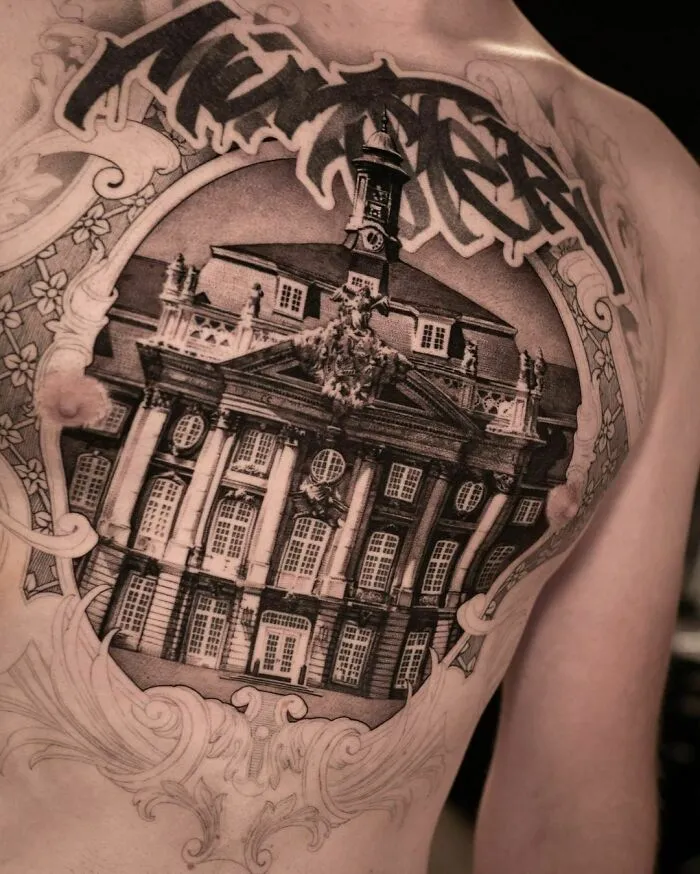 Chest tattoo of an unfinished mansion with graffiti, showcasing super realistic detailing and intricate design.
