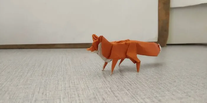 a red and white fox made out of the paper