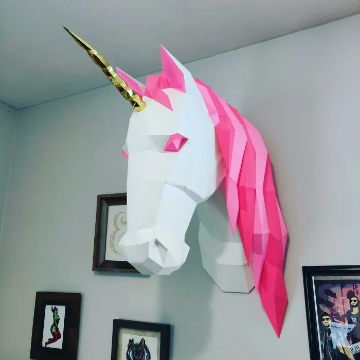 a paper white and pink unicorn with a golden horn