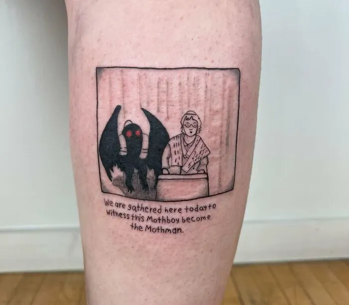 Creative word tattoo featuring Mothman illustration and phrase, inked on a person's leg.