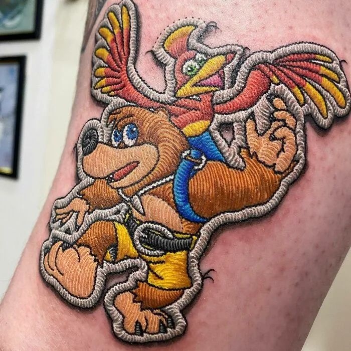 Realistic Banjo Tooie patchwork tattoo with intricate detailing.