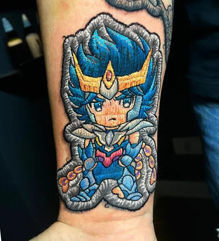 Tattoo by Eduardo Lozano featuring a vibrant anime-style character with blue hair and intricate details.
