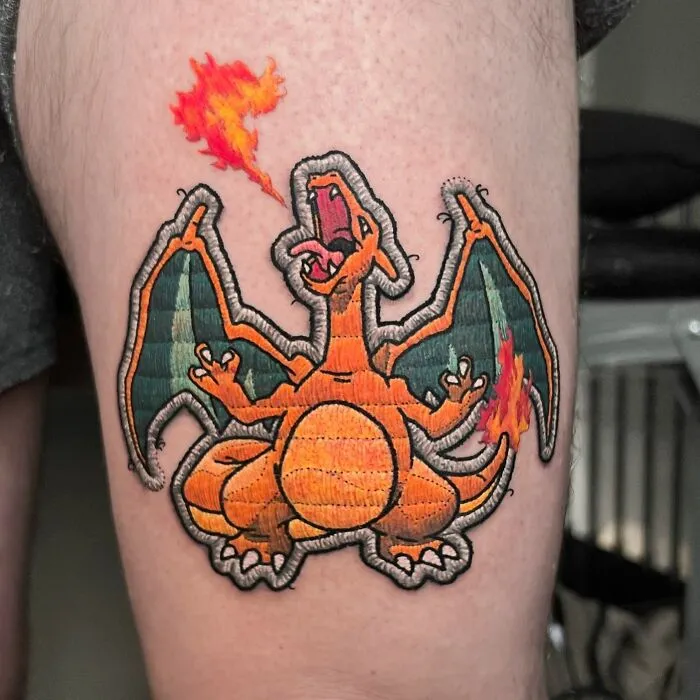 Tattoo of a fire-breathing dragon on a person's leg, showcasing Eduardo Lozano's unique tattooing style.