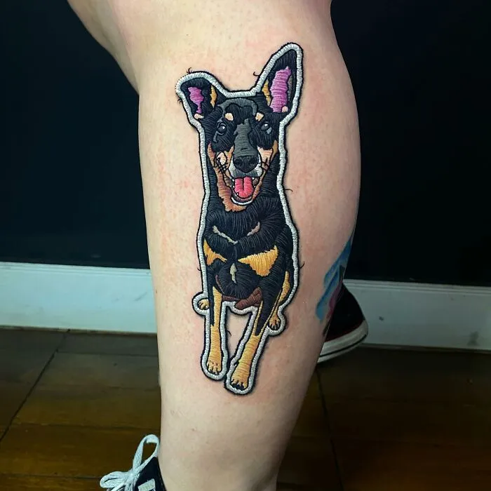 Tattoo of a realistic dog on a leg, showcasing Eduardo Lozano's unique dimension in tattooing.