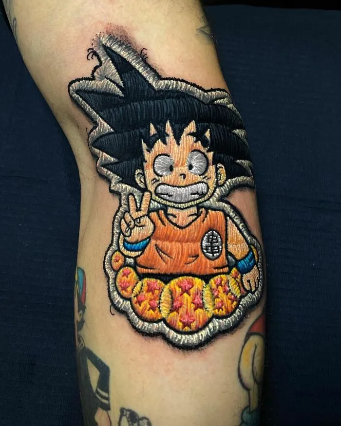 Tattoo by Eduardo Lozano featuring a 3D anime character design on an arm, showcasing unique embroidery style.