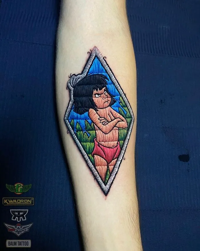Tattoo by Eduardo Lozano featuring a colorful character design on a forearm, showcasing unique dimension in tattooing.