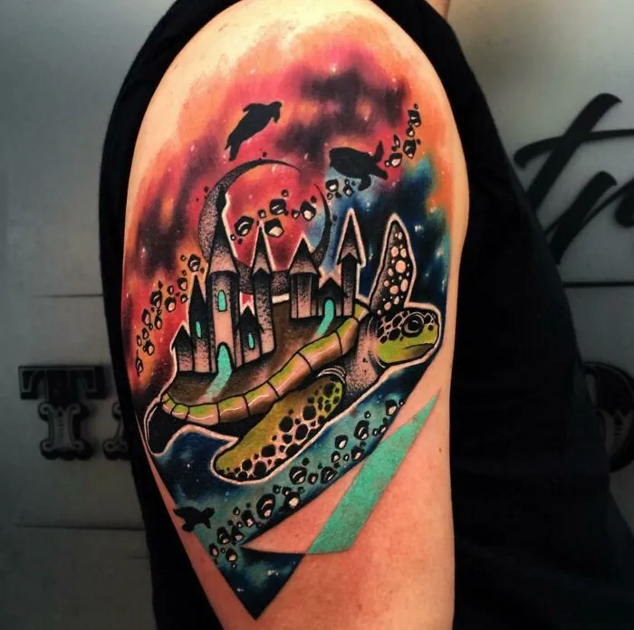 Space tattoo with cosmic sea turtle and castle, featuring vibrant outer space colors on an arm.