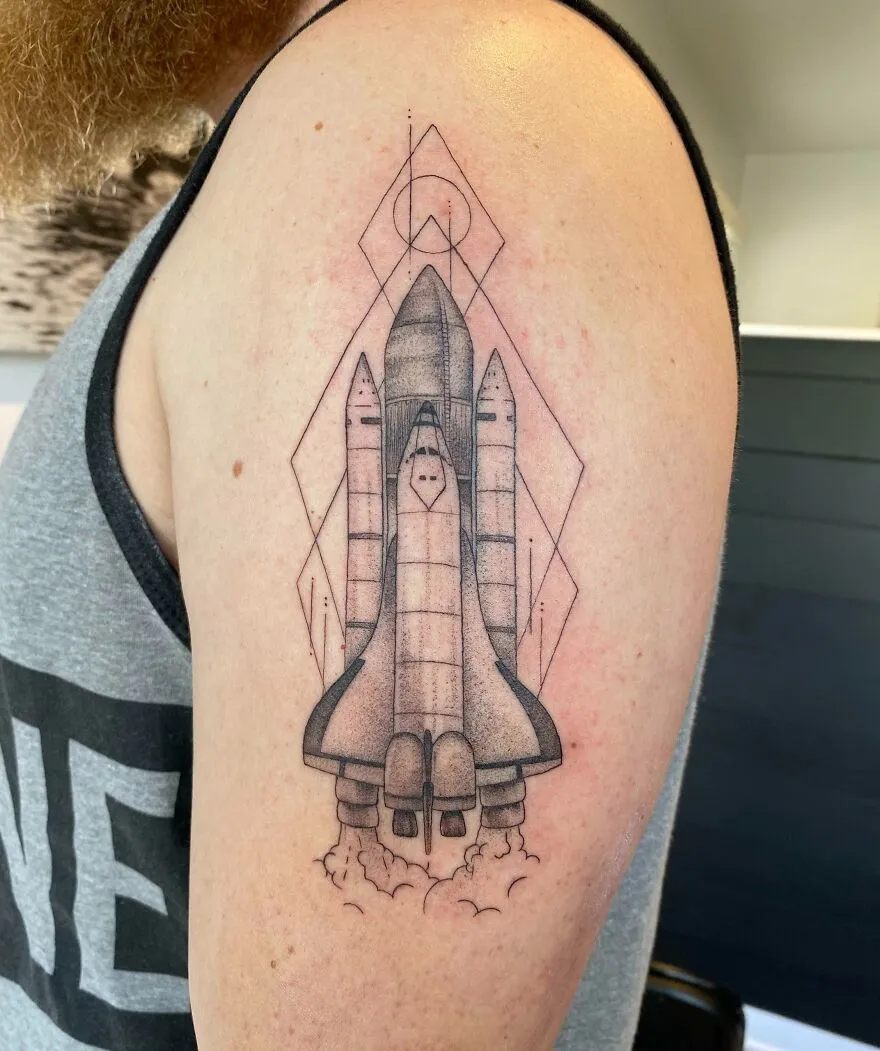 Space tattoo of a shuttle launching on an arm, showcasing outer space cool design.