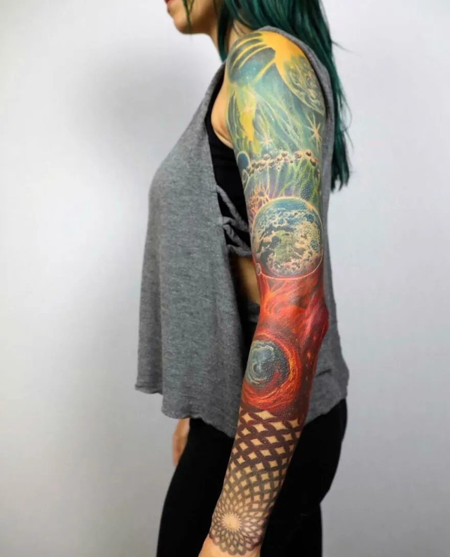 Colorful space tattoo sleeve featuring planets and cosmic designs on a woman's arm.