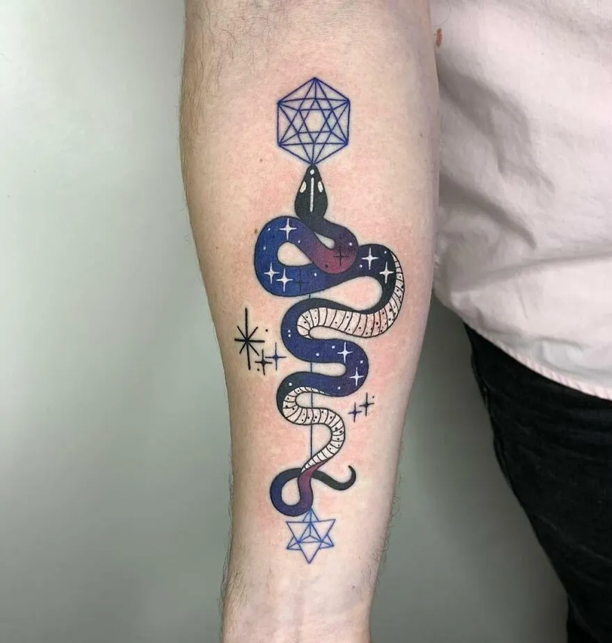 Snake tattoo with space theme, featuring stars and geometric shapes, on a forearm.
