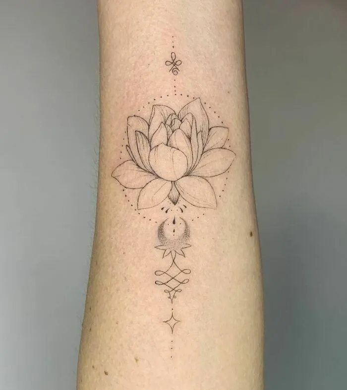 Elegant flower tattoo featuring a lotus design on forearm, showcasing beauty and intricacy.