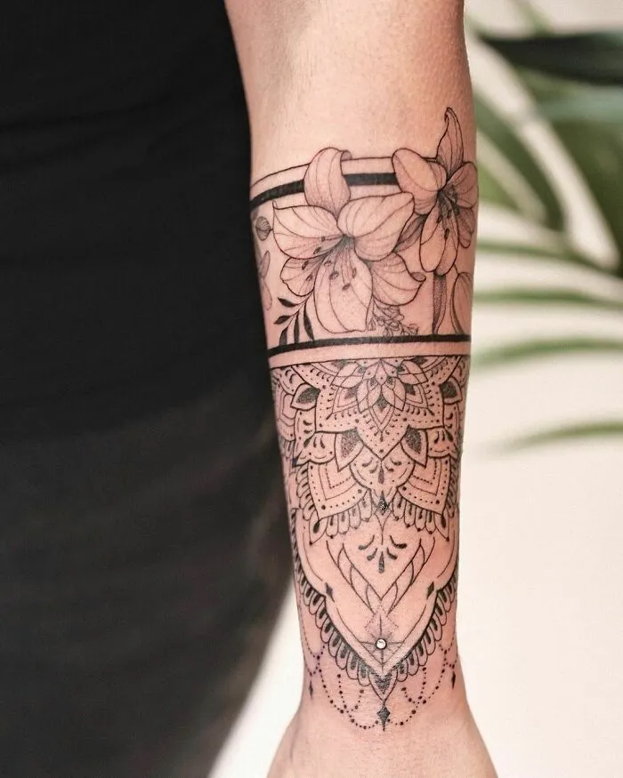 Elegant flower tattoo on forearm, showcasing intricate designs and beauty.
