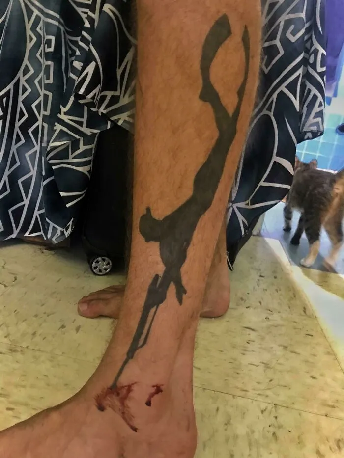 Tattoo of diver on leg with injury, creating a perfect accidental match with the situation.