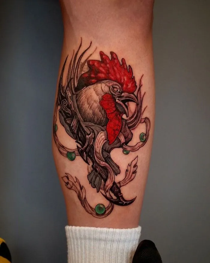 Unique calf tattoo featuring a vibrant rooster design with intricate details.