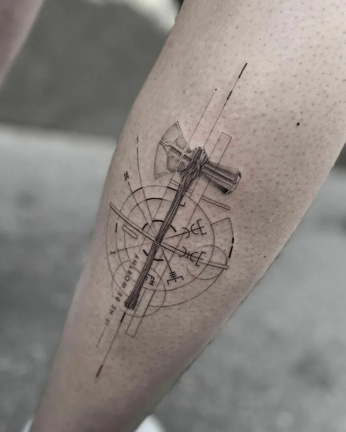 Geometric Marvel tattoo featuring Thor's hammer on forearm.