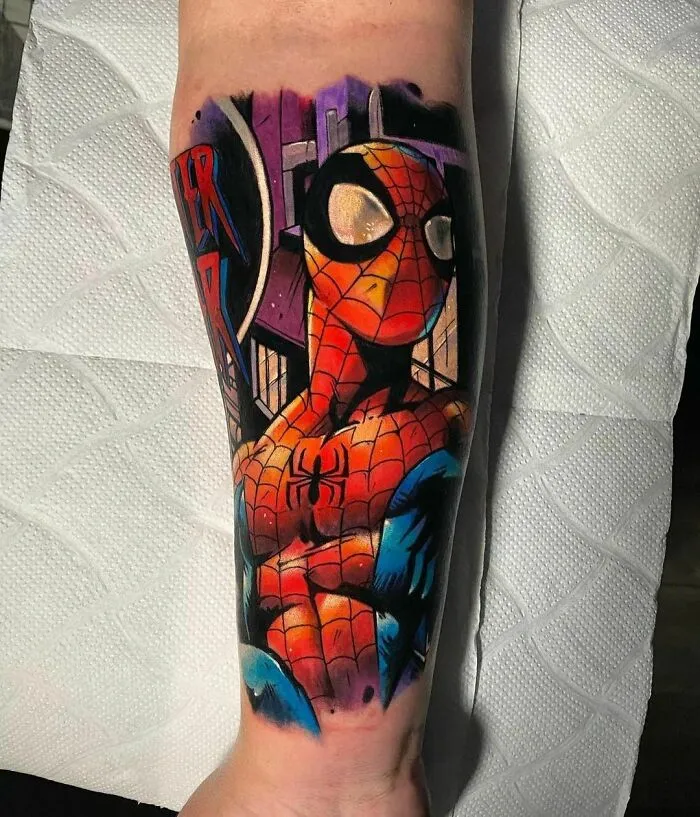 Marvel tattoo of Spider-Man on a forearm, showcasing vibrant colors and intricate details.
