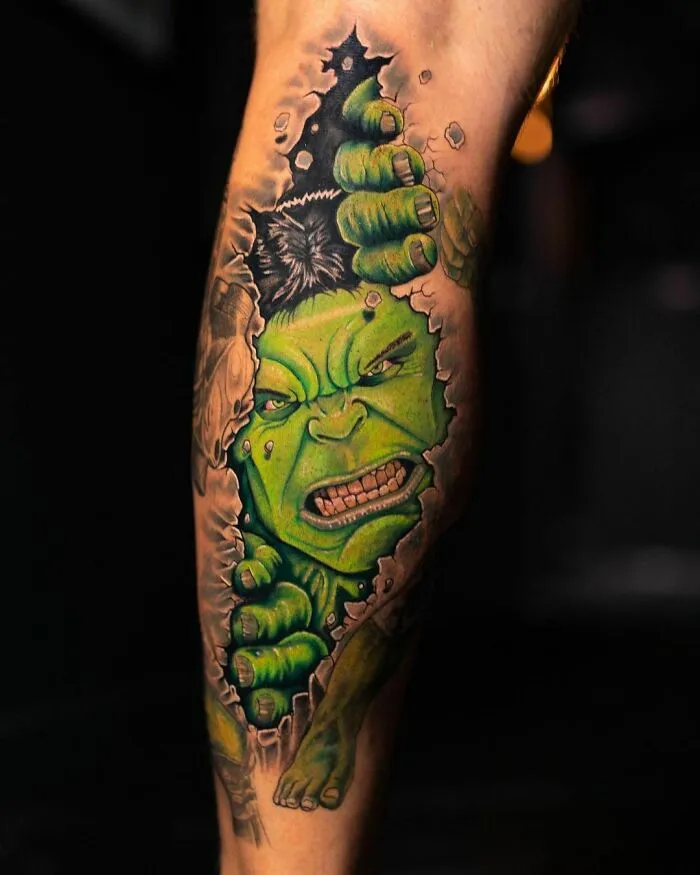Marvel tattoo of Hulk breaking through skin on a leg.