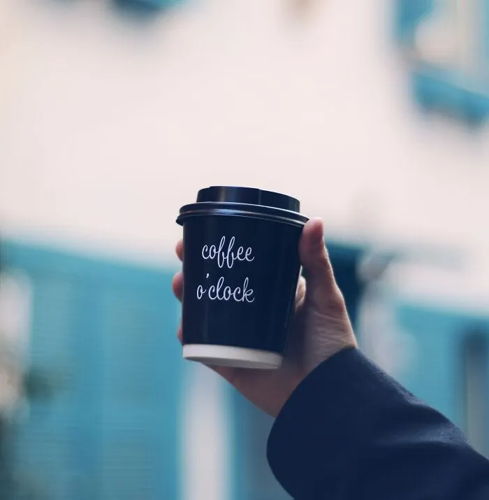 Person Holding A Coffee Cup 