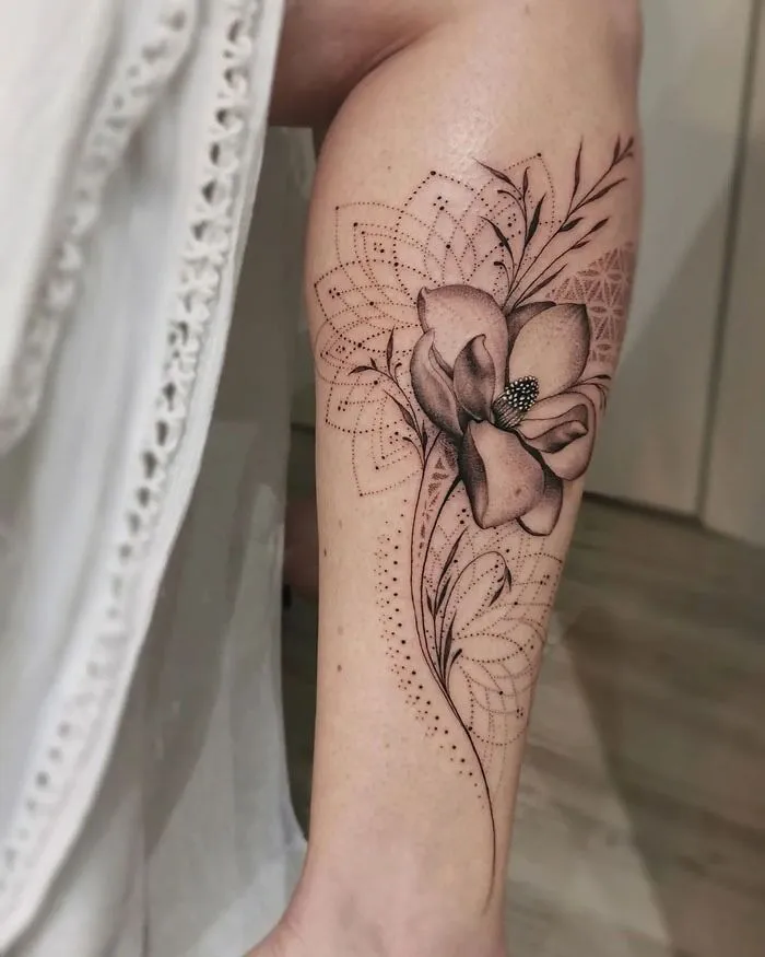 Elegant flower design calf tattoo, featuring intricate patterns and shading for a unique style.