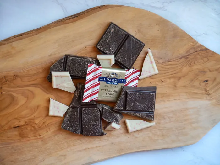 Split Ghirardelli chocolate on wooden table