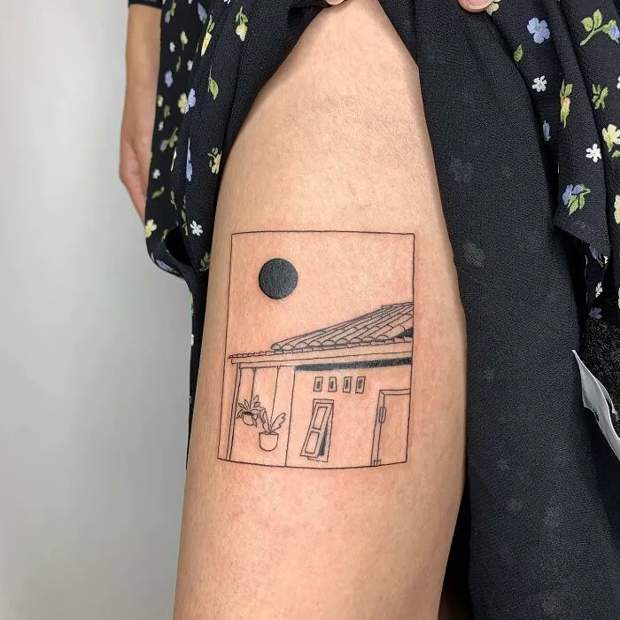 Illustration-like tattoo of a house with a sun on a person's leg.