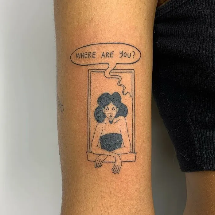 Illustration-style tattoo of a woman in a window with text bubble "Where are you?" on the arm.