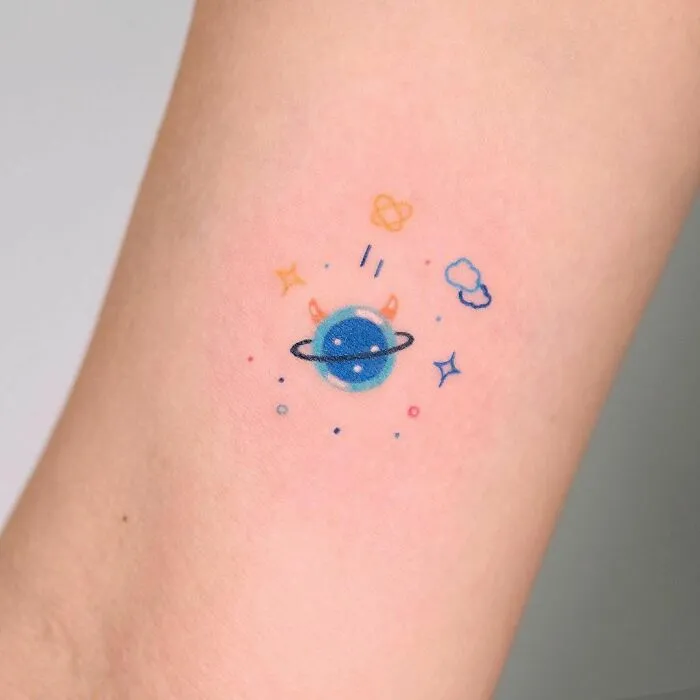 Minimal space tattoo with planets and stars on skin, showcasing outer space cool design.