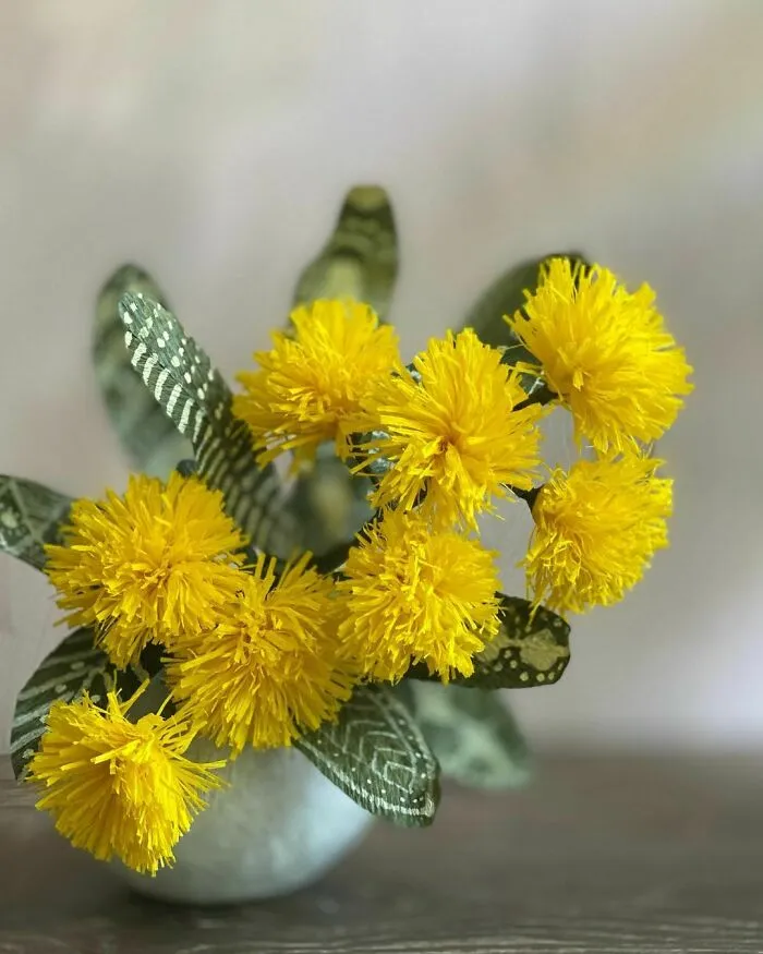 a yellow wattle flowers made out of the paper