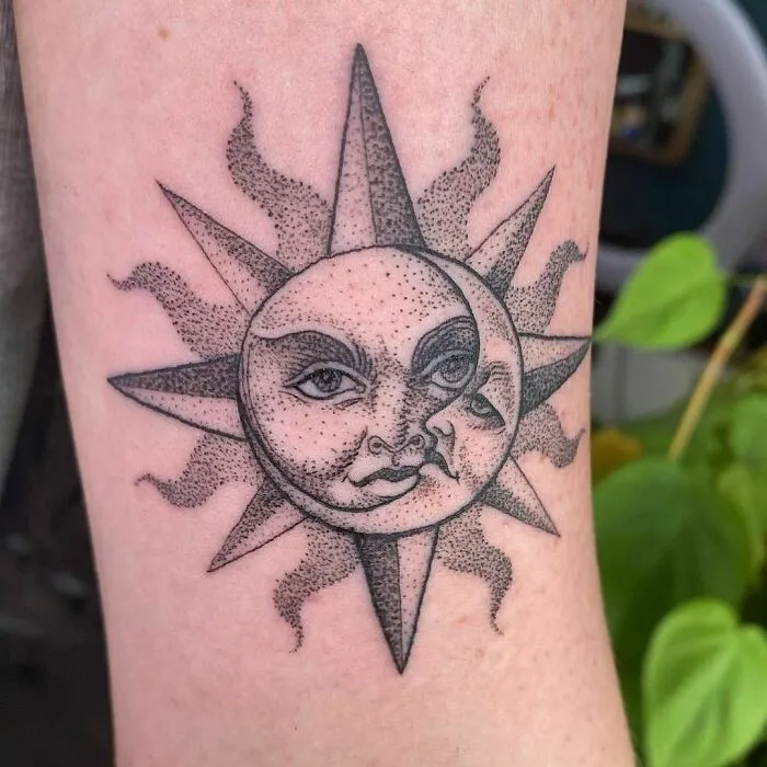 Tattoo of a stylized sun and moon with faces, representing outer space themes.